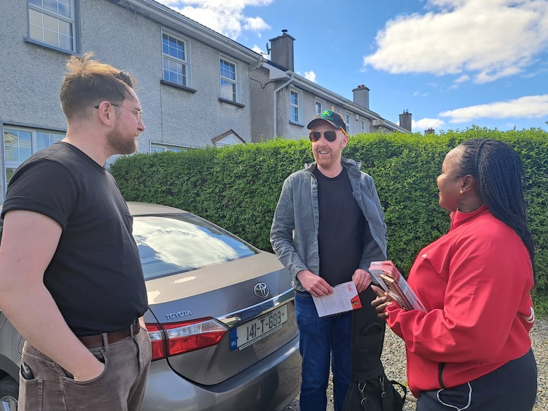 Helen Ogbu speaks with Ben McGowan and Niall Kenny in the Sandyvale Lawn estate in Galway City ahead of the 2026 Galway West byelection. Photograph: Andrew Hamilton