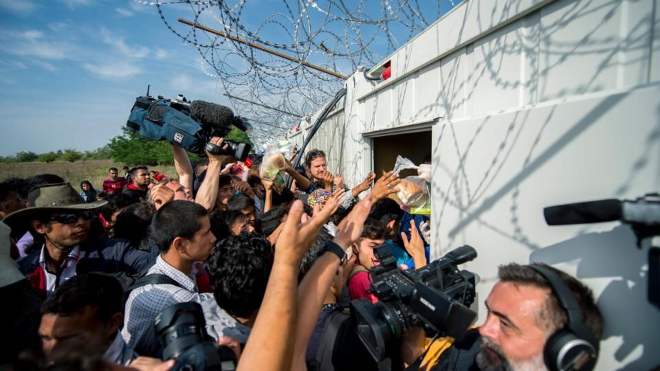 Police distribute food to migrants at the passing point in Horgos, Serbia, 15th September 2015. Photograph: Tamas SOKI/EPA