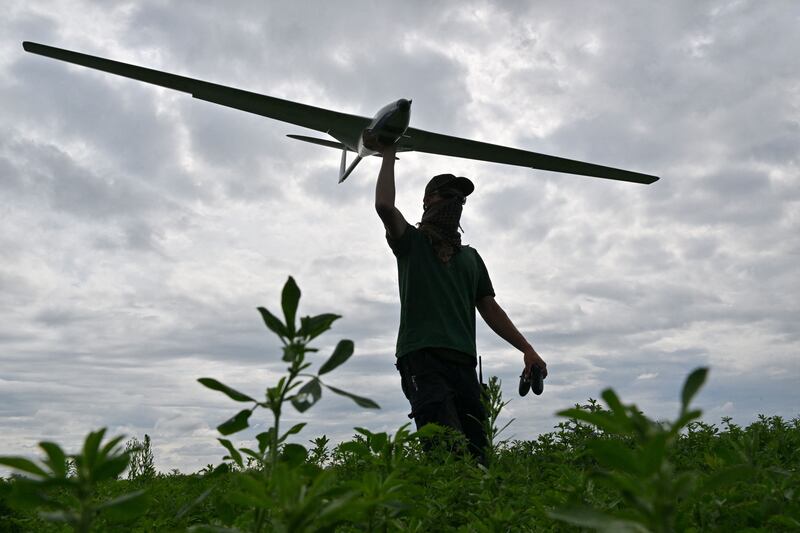 An operator carries a reusable airstrike drone  made by the Ukrainian company UA Dynamics during a test in Kyiv region in August  2023. Photograph: Sergei Supinsky/AFP via Getty Images