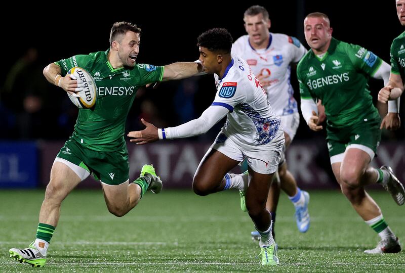 Caolin Blade fends off a Canan Moodie challenge in a Connacht v Vodacom Bulls URC match at Dexcom Stadium in November. Photograph: James Crombie/Inpho