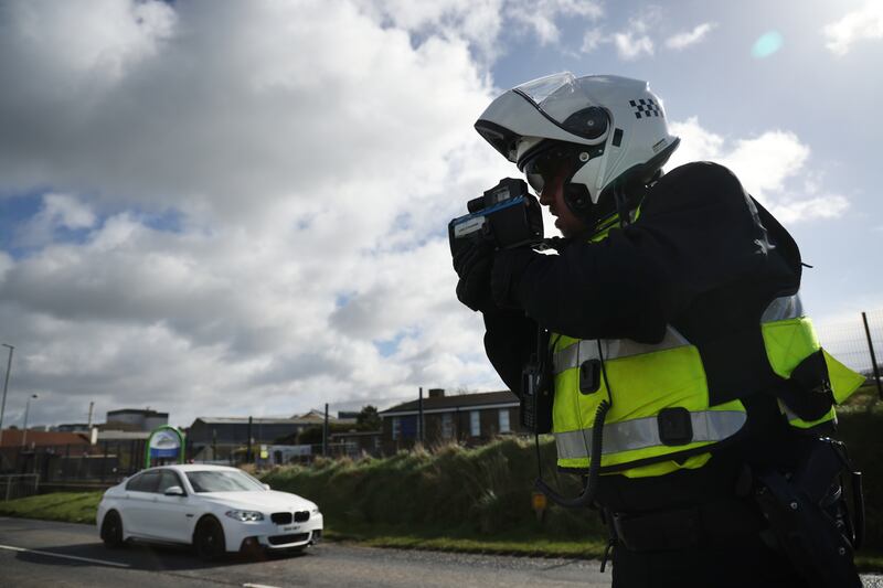  PSNI Officers operate speed detection devices on the road outside Artigarvan Primary School, Strabane.  Photo: Bryan O’Brien / The Irish Times  
