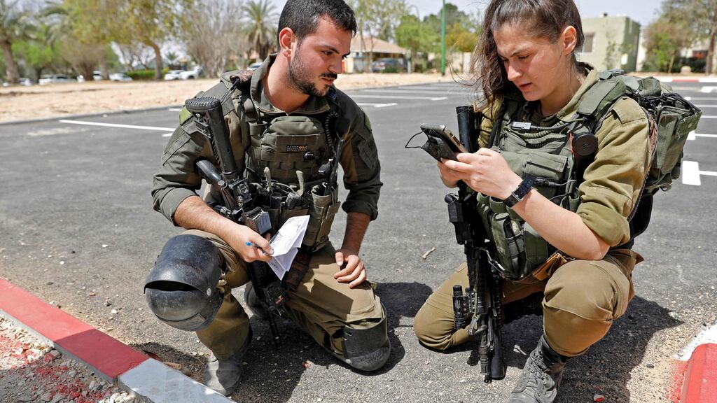 Israeli soldiers inspect a piece of debris after a missile launched from Syria landed in the vicinity of the Dimona nuclear site in Israel’s southern Negev desert. Photograph: Getty Images