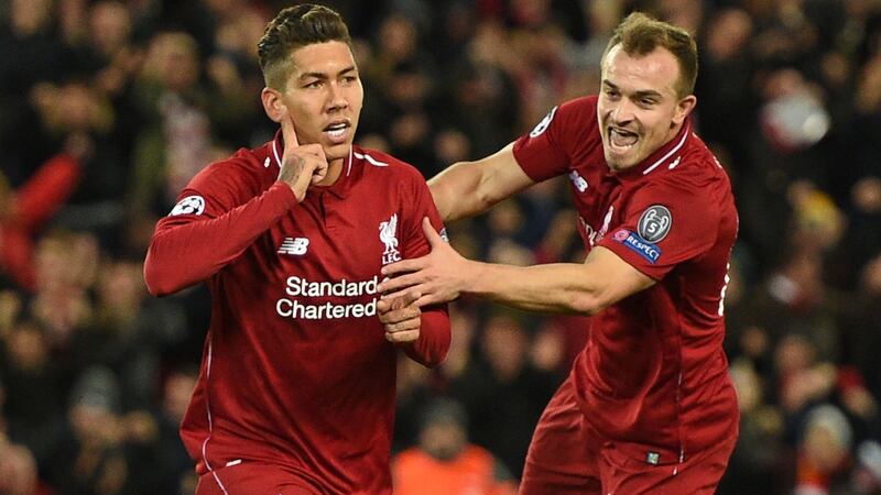 Xherdan Shaqiri celebrates with  Roberto Firmino after the Brazilian  opened the scoring in the Champions League Group C  match against  Red Star Belgrade at Anfield. Photograph: Oli Scarff/AFP/Getty Images