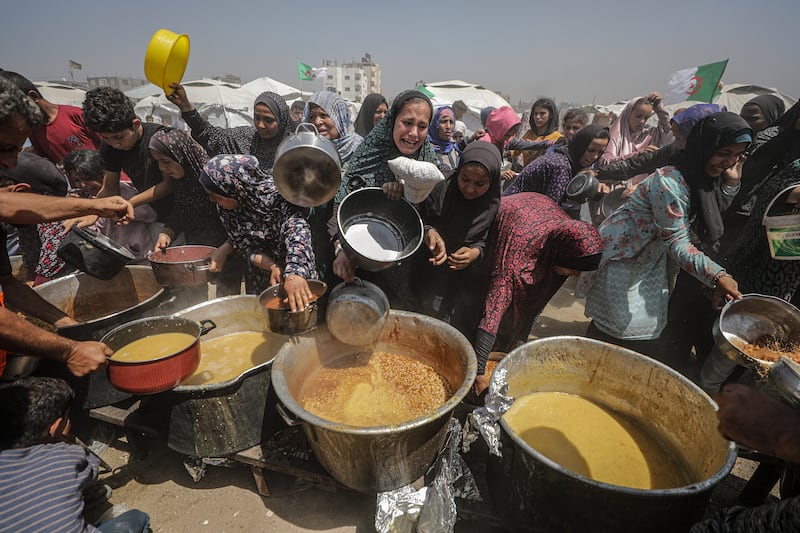 Internally displaced Palestinians gather to receive a portion of food from a charity kitchen, in Jabalia refugee camp, northern Gaza Strip. Photograph: Mohammed Saber/EPA