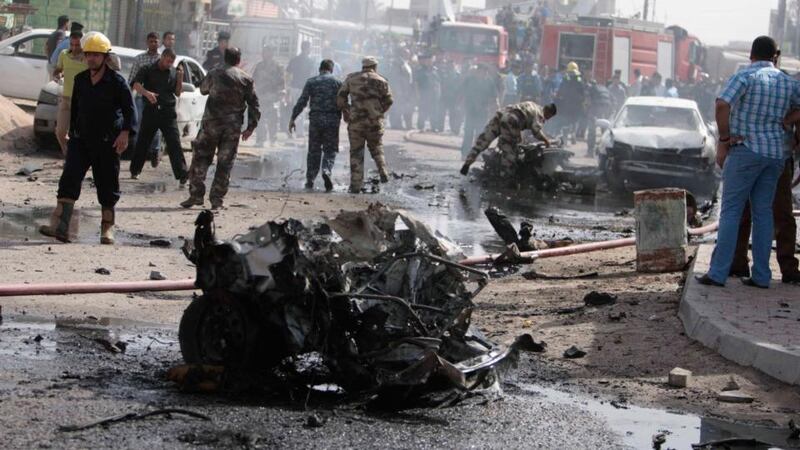 Iraqi security forces  inspect the site of a bomb attack in Basra, 420km  southeast of Baghdad. Photograph: Reuters