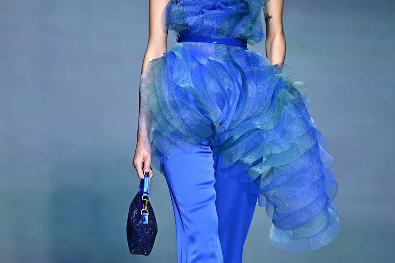 A model walks the runway of the Giorgio Armani show during the Milan Fashion Week Womenswear Spring/Summer 2024. An Italian court placed under judicial administration a company owned by Armani accused of indirectly subcontracting production to Chinese companies that exploited workers. Photograph: Gabriel Bouys/AFP via Getty Images