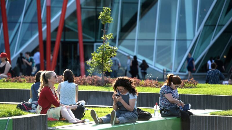 Enjoying the early evening weather last summer around the Grand Canal Square area in Dublin. Photograph: Dara Mac Dónaill/The Irish Times