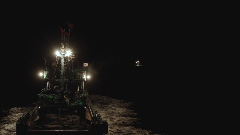 Chinese squid vessel flying Korean flag at night. Photograph: Fábio Nascimento