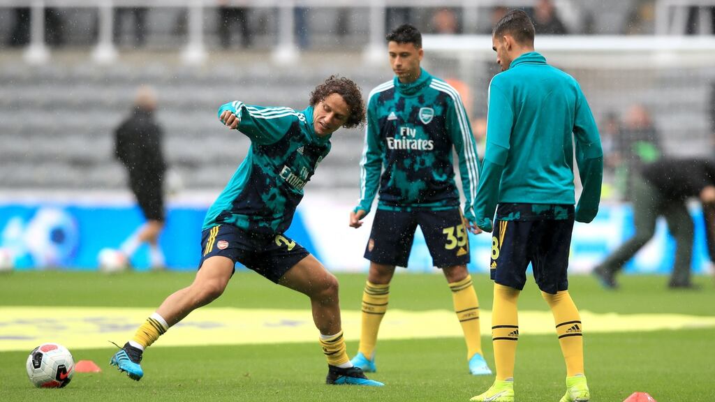 Arsenal’s David Luiz (left) during the pre-match warm up prior to their Premier League meeting with Arsenal at St James’ Park. Photo: Owen Humphreys/PA Wire