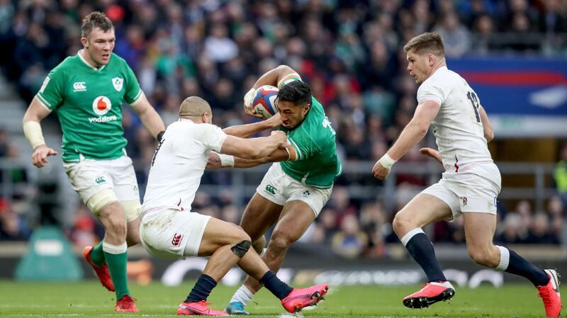 Bundee Aki is tackled by Jonathan Joseph at Twickenham. Photograph: Dan Sheridan/Inpho
