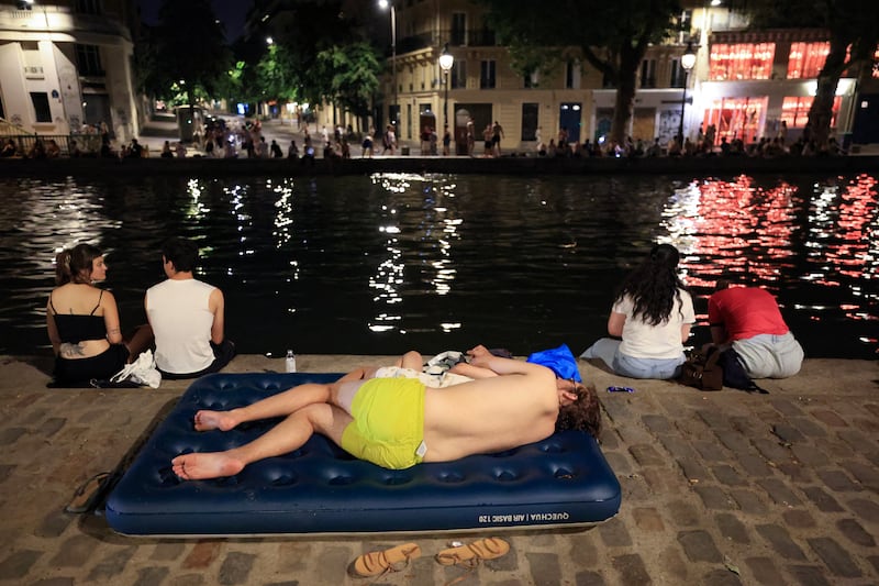A youth cools down along the Canal Saint-Martin as France experiences a heatwave, in Paris. Photograph: Ludovic Marin/AFP via Getty Images