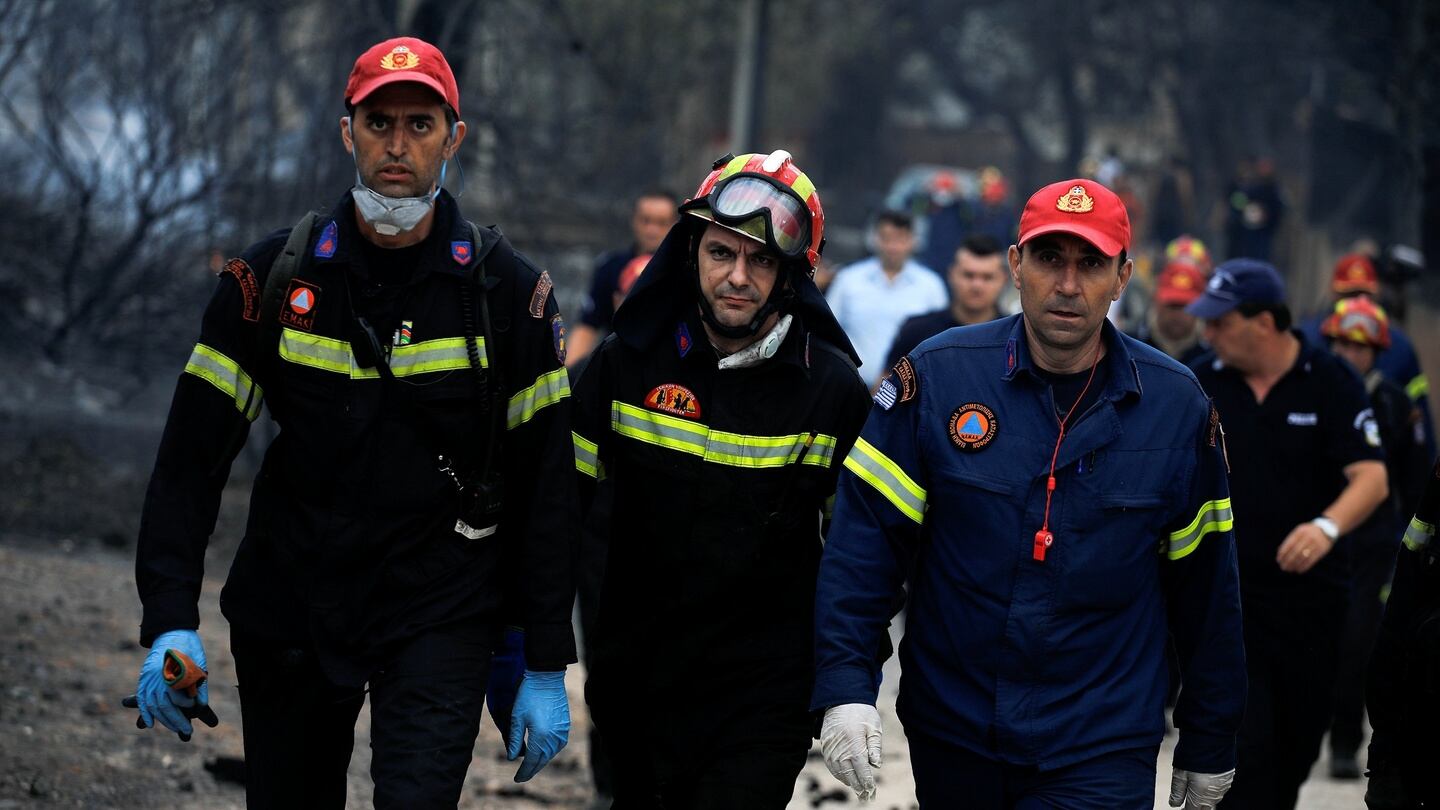 Rescuers arrive at the area where bodies were found following a wildfire at the village of Mati. Photograph: Alkis Konstantinidis/Reuters