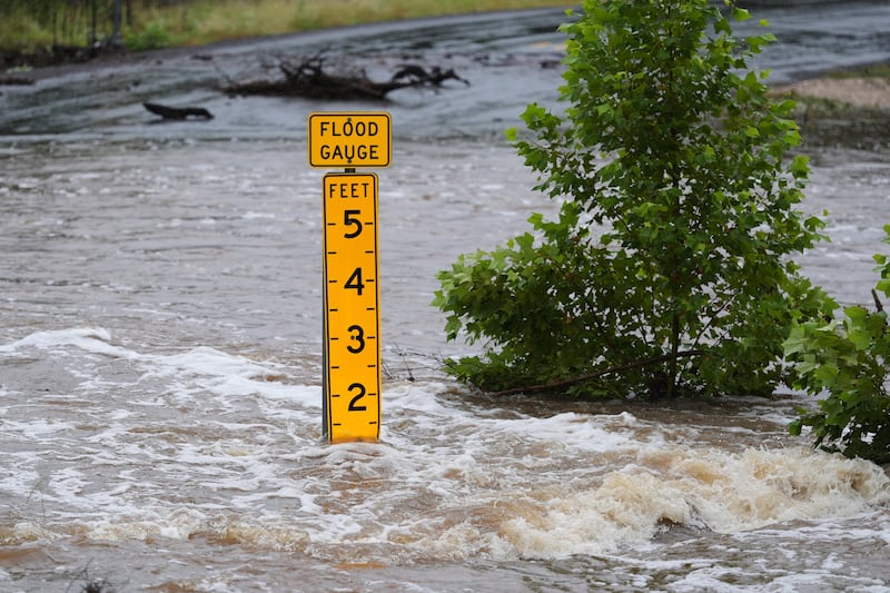 A flood gauge marks the height of water flowing over a farm-to-market road near Kerrville, Texas. Photograph: Eric Gay/AP