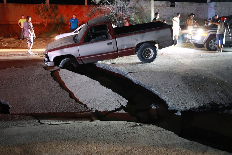A vehicle is trapped in a fissure in La Guaira. Photograph: Javier Campos/AP