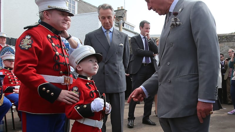 The Prince of Wales meets flute band master Paul Elliot and his son Sam (7), during a visit to the Orange Order heritage museum in Loughgall, Co Antrim. Photograph: Niall Carson/PA Wire