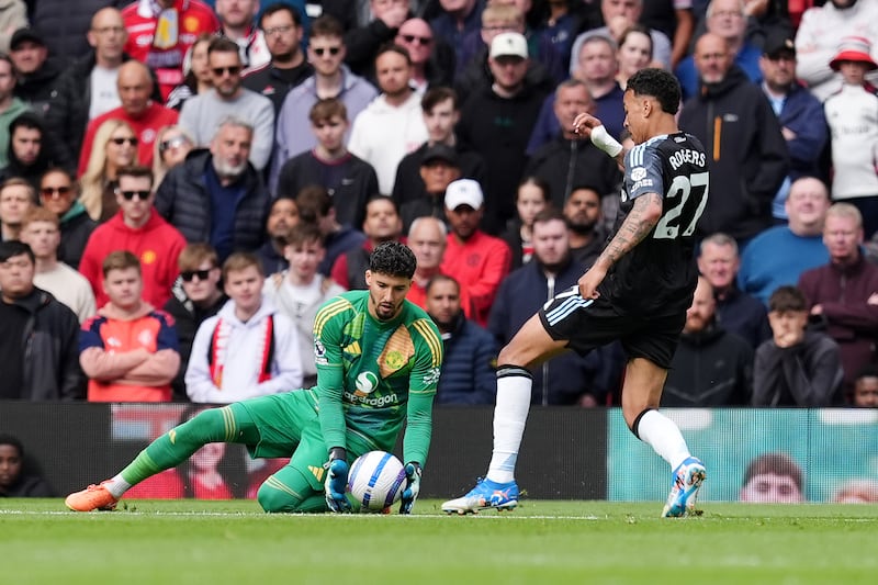 Aston Villa's Morgan Rogers kicks the ball away from Manchester United goalkeeper Altay Bayindir. Photograph: Martin Rickett/PA