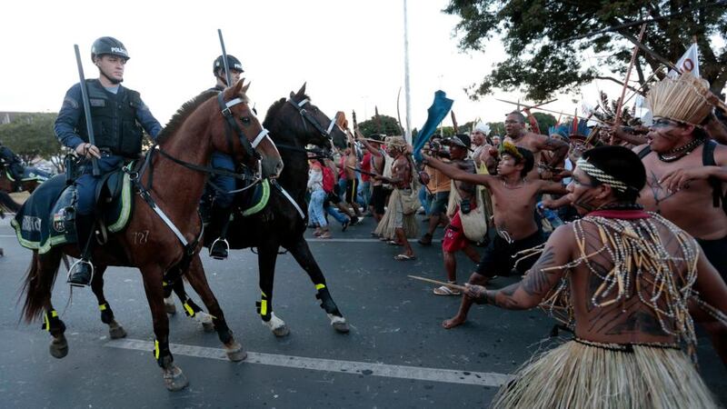 Police confront native Brazilians to prevent them from marching towards the Mane Garrincha soccer stadium during a demonstration in Brasilia last night.  Photograph: Reuters