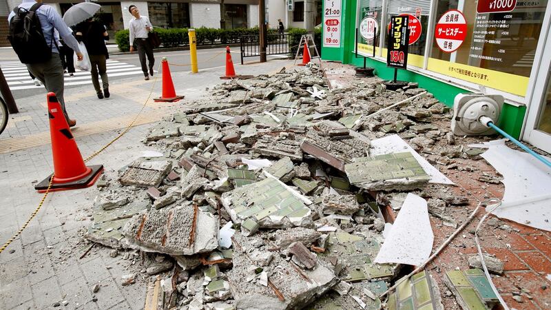 Debris of damaged walls are scattered following an earthquake, in Ibaraki, Osaka. Photograph: Yosuke Mizuno/Kyodo News via AP