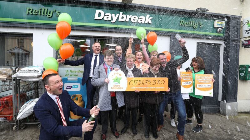 Les Reilly, owner of Reilly’s Daybreak Store in  Naul, north Co Dublin, where the winning EuroMillions ticket was sold, celebrating with staff, customers and David Woods (left) of the National Lottery. Photograph: Mac Innes Photography
