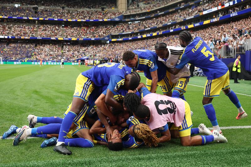 Livano Comenencia is engulfed by celebrating team-mates after equalising for Curaçao against Germany in Sunday's World Cup Group E match in Houston, Texas. Photograph: Alexander Hassenstein/Getty Images