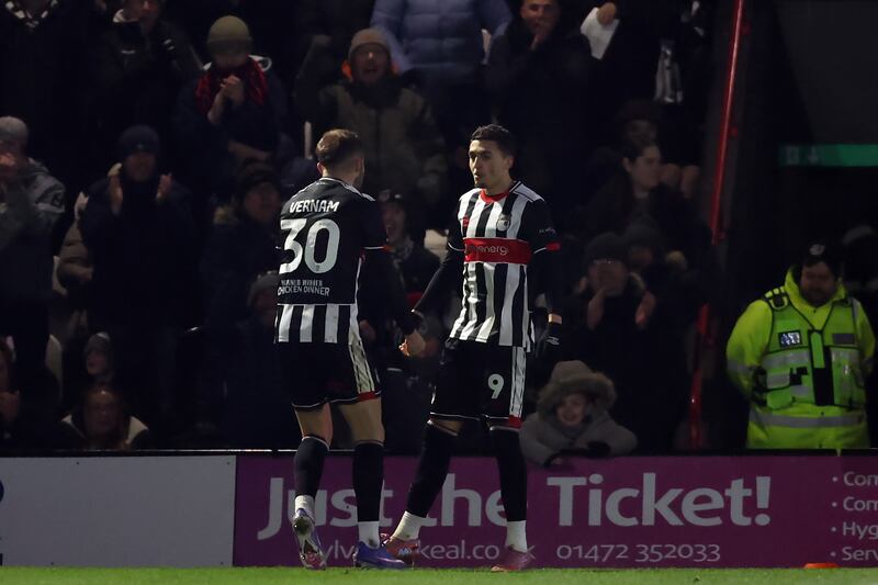 Grimsby Town's Jaze Kabia (right) celebrates scoring side's second goal of the game. Photograph: Nigel French/PA