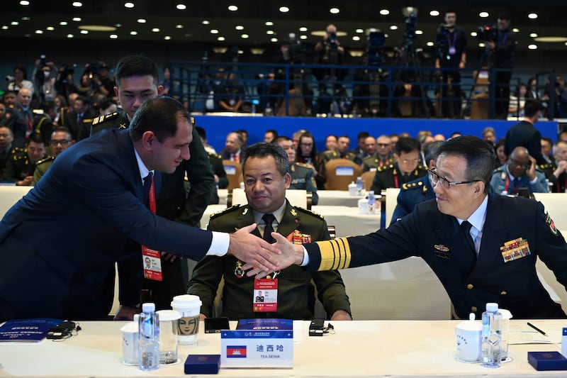 Chinese defence minister Dong Jun (right) shakes hands with Armenian defence minister Suren Papikyan (left) as Cambodia's defence minister Tea Seiha (centre) looks on at the Xiangshan Forum in Beijing earlier this month. Photograph: Greg Baker/AFP via Getty Images          