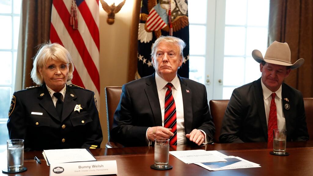 Donald Trump, with Carolyn “Bunny” Welsh, sheriff of Chester County, Pennsylvania (L) and AJ Louderback, sheriff of Jackson County, Texas, attends a roundtable discussion on border security in the cabinet room of the White House on Friday. Photograph: Jacquelyn Martin/AP