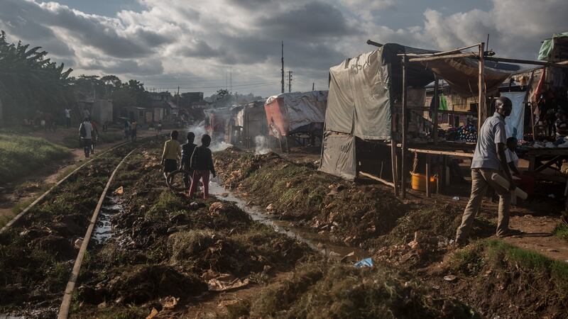 Children play along the train tracks in Namuwongo, Kampala. Photograph: Sally Hayden