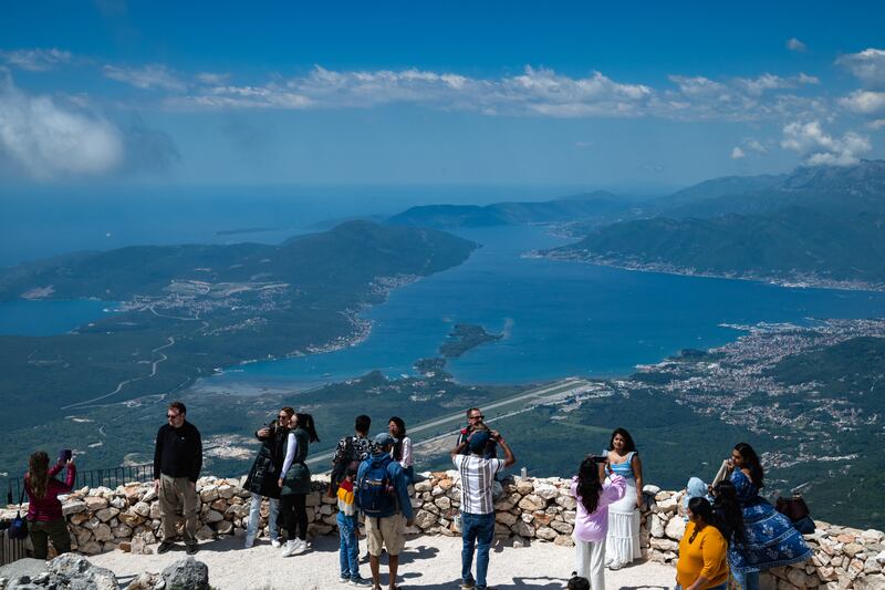 Tourists visit a viewpoint above Montenegro's Adriatic coastal town of Tivat. Photograph:  Andrej Isakovic/AFP/Getty