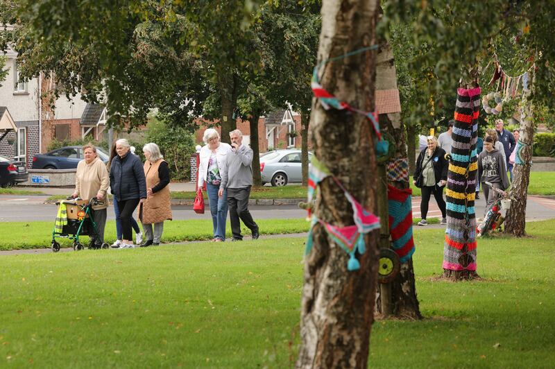 Resdients pass yarn-bombed trees on their way to the ribbon-cutting ceremony in the estate. Photograph: Alan Betson