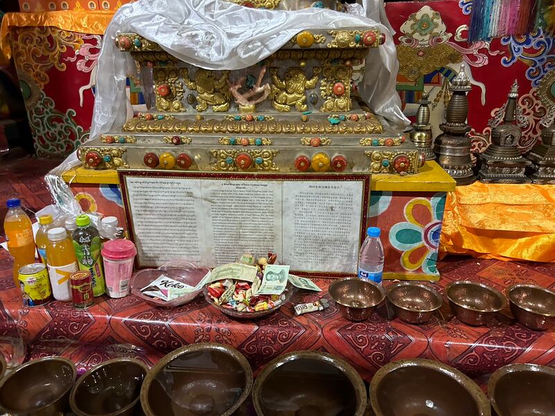 Pilgrims’ offerings below a statue of Buddha at Sangpiling monastery. Photograph: Denis Staunton 