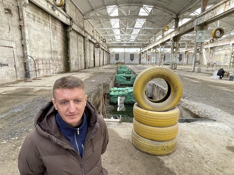 'Radio', a spokesman for Ukraine's 3rd Army Corps, stands in front of a mock-up of a battlefield trench that is part of a training area for soldiers and civilians learning how to fly drones. Photograph: Daniel McLaughlin