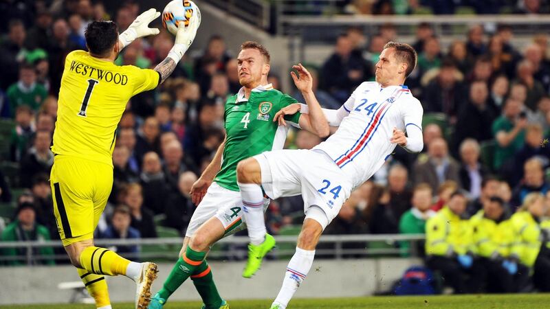 Kieren Westwood clears from Kjartan Henry Finnbogason. Photo: AIdan Crawley/EPA