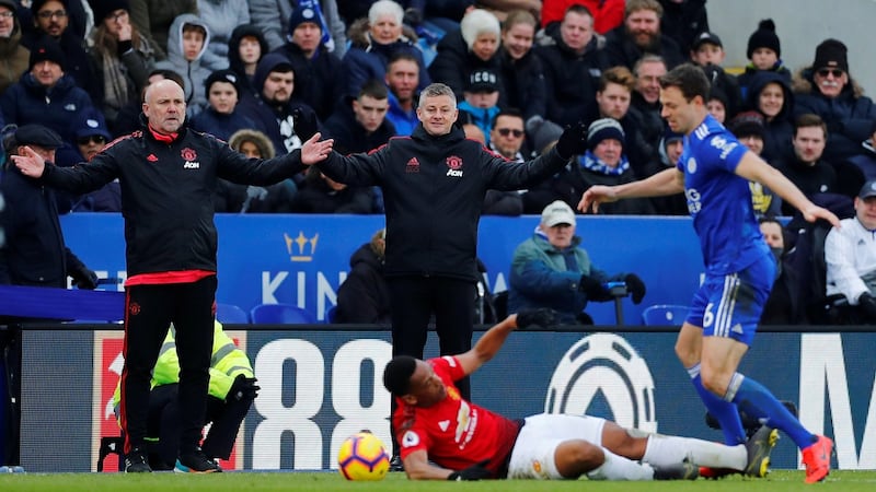 Mike Phelan and Ole Gunnar Solskjear look on after Anthony Martial is fouled by Jonny Evans. Photograph: Eddie Keogh/Reuters