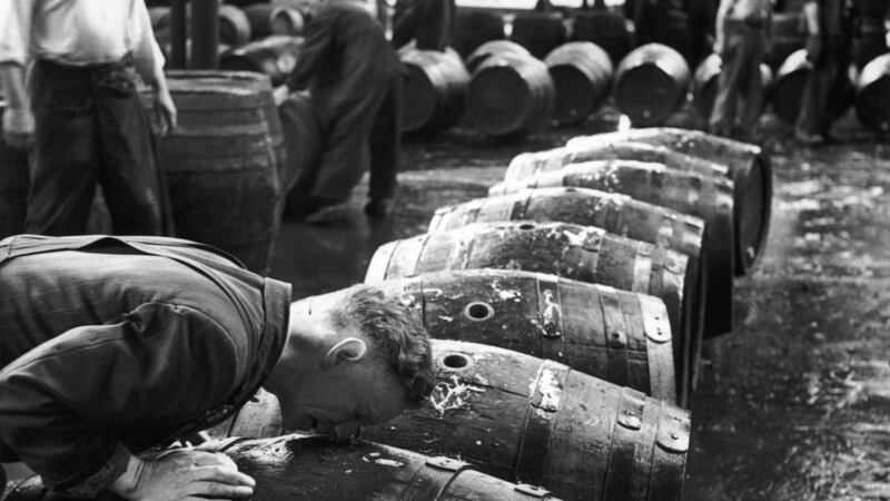 A 'smeller' sniffs scalded casks to check their cleanliness, at the Guinness brewery at St. James's Gate, Dublin, August 22nd, 1953. Photo by Bert Hardy/Picture Post/Hulton Archive/Getty Images