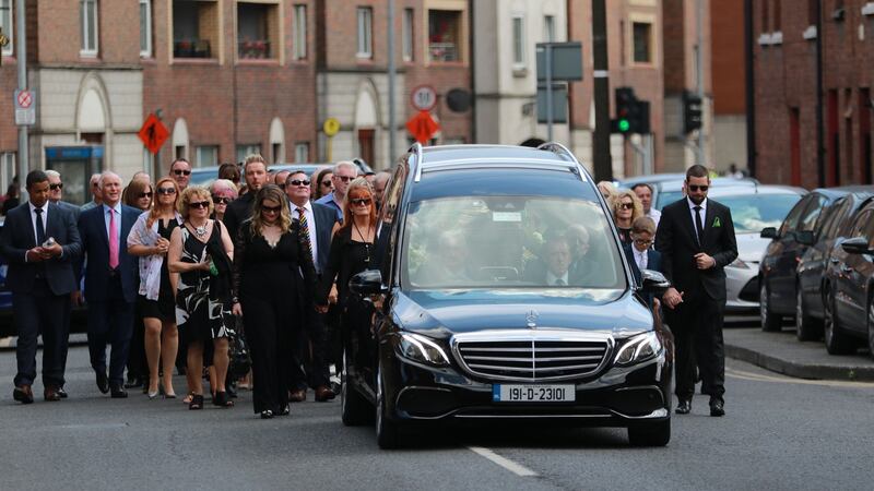 Family and friends following the hearse in the Liberties on their way to the funeral Mass of comedian Brendan Grace. Photograph: Nick Bradshaw/The Irish Times