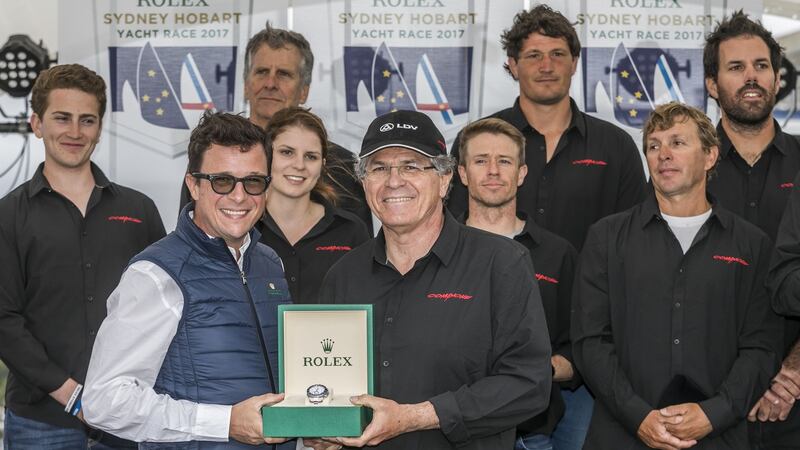 Jim Cooney, centre,  owner of Australian super-maxi yacht Comanche, celebrates victory in the Sydney to Hobart yacht race with his crew. Photograph: Luca Butto/AFP/Getty Images