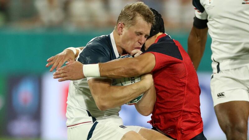 USA fullback Will Hooley is  tackled by England’s Piers Francis in the first minute during the Rugby World Cup  Group C game at Kobe Misaki Stadium. Photograph:  David Rogers/Getty Images