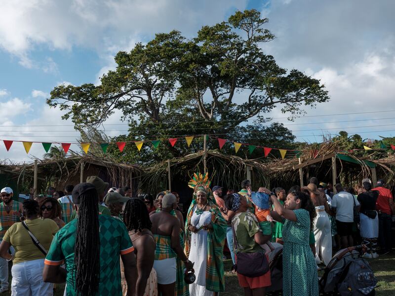 People gather in a park among food stalls on St Patrick’s Day in Salem, Montserrat. Photograph: Luis Antonio Rojas/The New York Times
                      