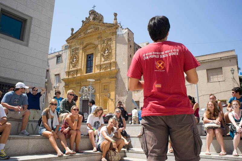 An Addiopizzo guide in Palermo: his T-shirt reads, 'A whole people which pays protection money is a people without dignity.' Photograph: Addiopizzo Travel 