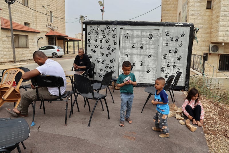 Displaced people in front of the university building where they now live. Photograph: Hannah McCarthy
