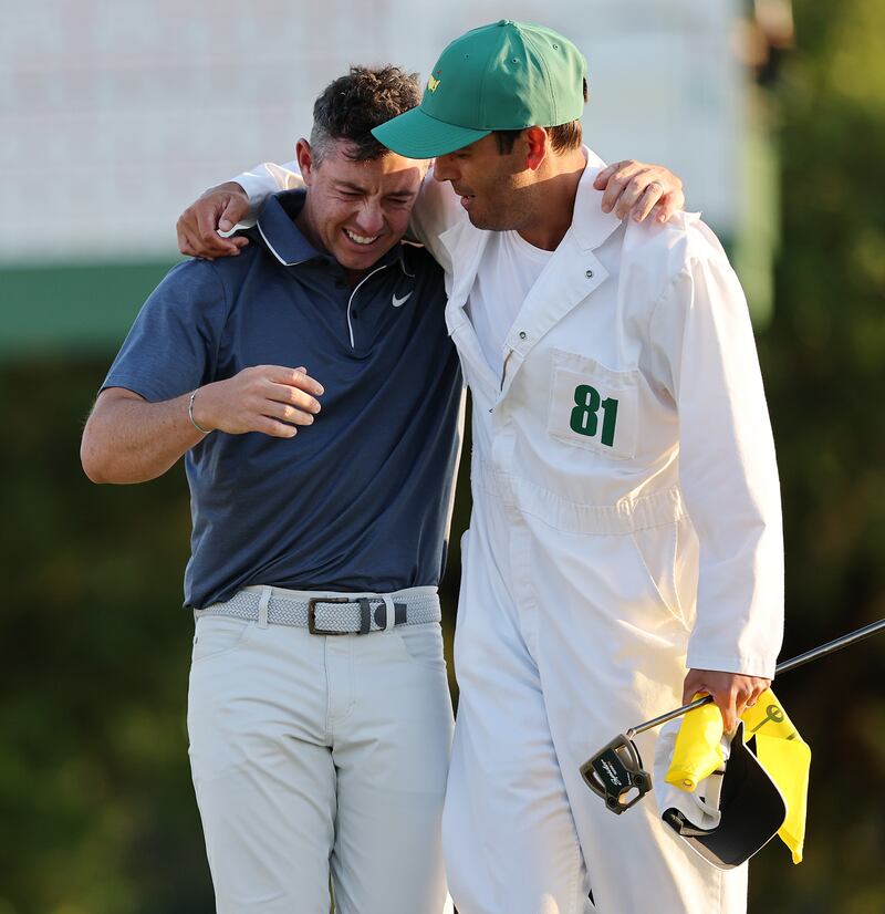 Rory McIlroy of Northern Ireland celebrates winning with caddie Harry Diamond.  Photograph: Michael Reaves/Getty Images