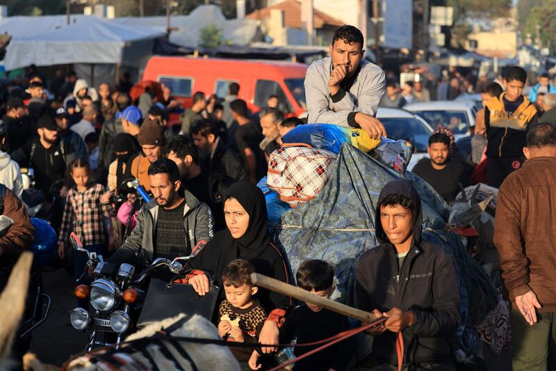 Palestinians who had taken refuge in temporary shelters return to their homes in eastern Khan Yunis in the southern Gaza Strip during the first hours of a four-day truce in the battles between Israel and Hamas. Photograph: MAHMUD HAMS/AFP via Getty Images
