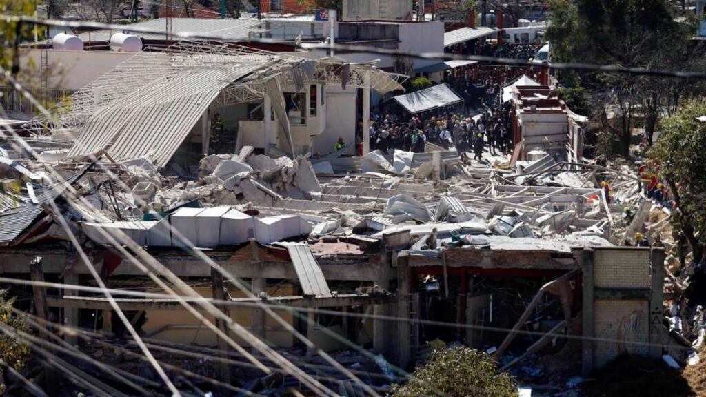 Rescue workers at the site of an explosion at a maternity hospital in Mexico City. The explosion rocked the maternity hospital when a leak from a gas truck ignited. Photograph: Edgard Garrido/Reuters