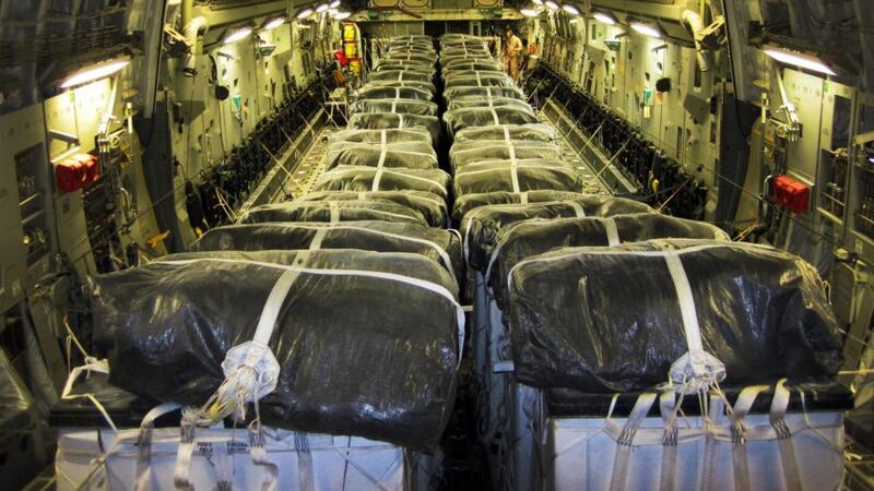A handout picture made available by the US department of defense today  shows pallets of bottled water being loaded aboard a US Air Force C-17 Globemaster III aircraft in preparation for a humanitarian airdrop over Iraq.