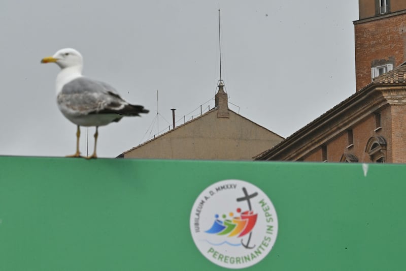 This photograph shows a seagull on a placard with the logo of the 2025 Jubilee with the Sistine Chapel and its chimney in the background, at The Vatican,Photo by ANDREAS SOLARO/AFP via Getty Images
