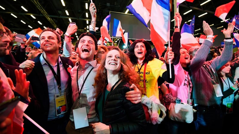 Supporters of Emmanuel Macron, French presidential election candidate for the En Marche! movement, celebrate after the results of the first round of the presidential election,  at the Parc des Expositions in Paris. Photograph: Eric Feferberg/AFP/Getty Images