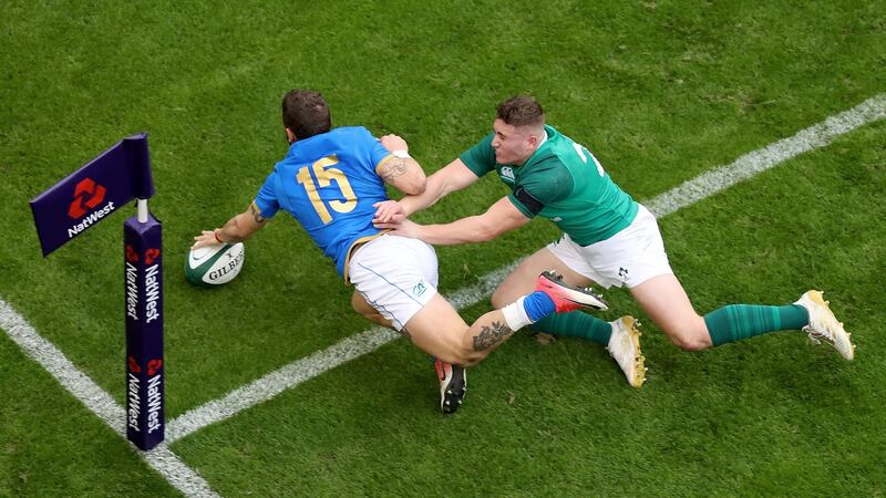 Matteo Minozzi scores ahead of Jordan Larmoudr. Photograph: Tommy Dickson/Inpho