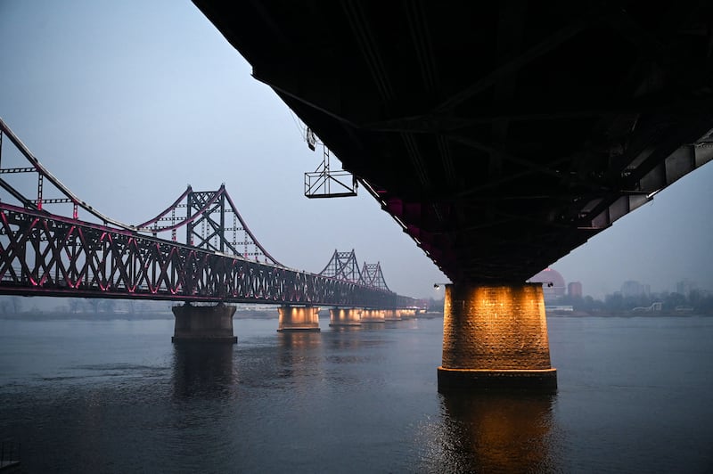The Yalu River Broken Bridge and the Sino-Korean Friendship Bridge span the Yalu River, which marks the border between North Korea and China. Photograph: Greg Baker/AFP/Getty Images