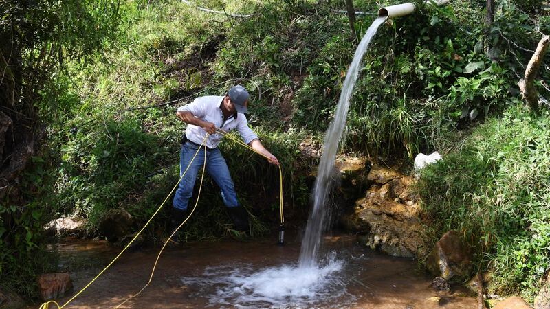 Victor Sandoval of the University of San Carlos of Guatemala collects water samples for analysis near the Lempa river source in Olopa,  east of Guatemala city. Photograph: Marvin Recinos/AFP/Getty Images